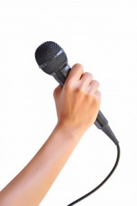 Holding-a-microphone-199x300